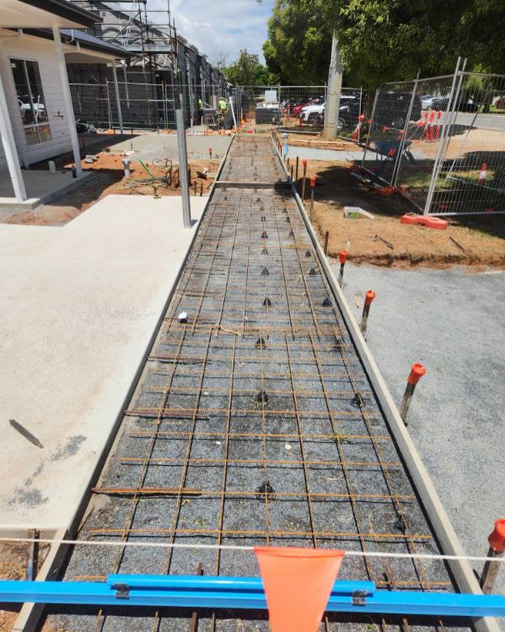 Reo mesh laid and ready for a concrete pathway pour at a townhouse build