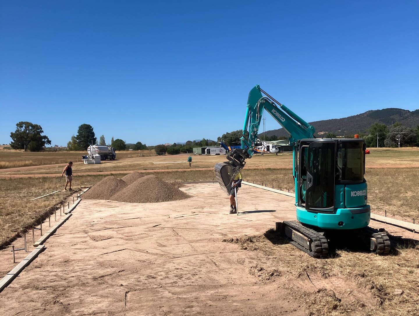 Helipad mid-build with formwork set and the Earth Haul Excavations branded excavator on site