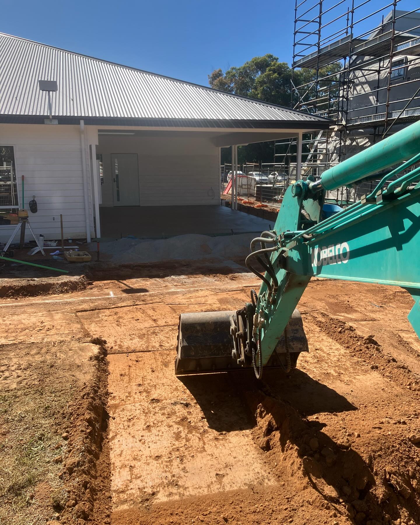 Earth Haul Excavations branded Kobelco excavator levelling ground at a new build site near Benalla
